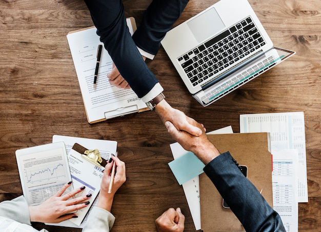 Handshake over official BOI certification documents required for business and worker compliance in Thailand
