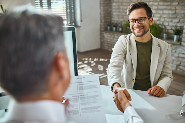 Happy man shaking hands with an employer