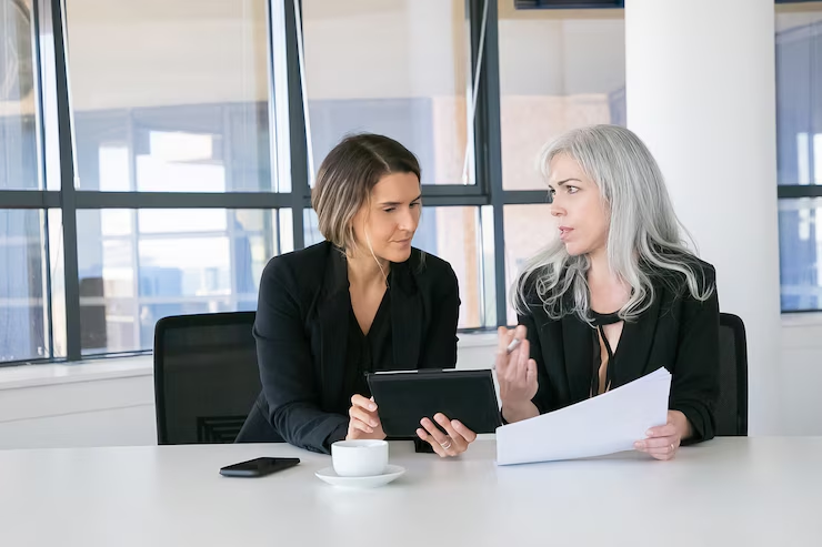 Australian investor reviewing company documents for DIFC compliance in a business setting