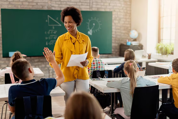 Australian teacher high-fiving a child in class