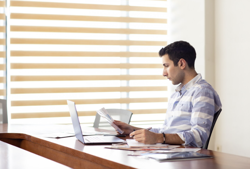 An expert from Authentifier reviewing official documents to prepare them for the multi-step attestation process.