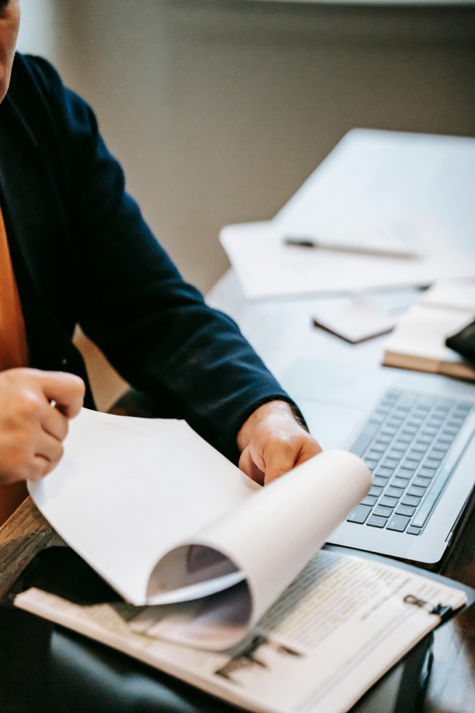 A person carefully reviewing legal and official documents