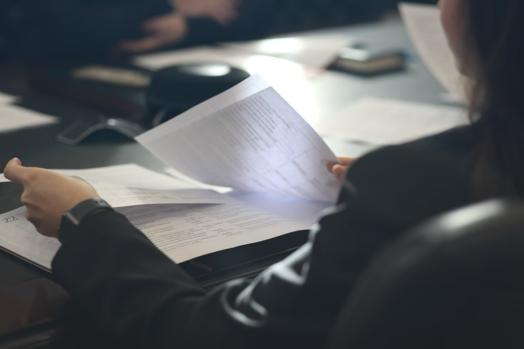 A person carefully reviewing official documents.