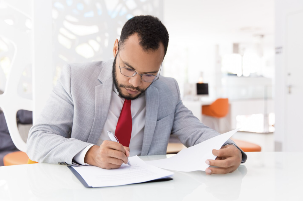 A person reviewing documents in an office.